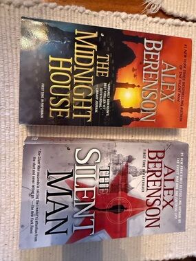 2 paperback books by Alex Berenson, The Silent Man and The Midnight house